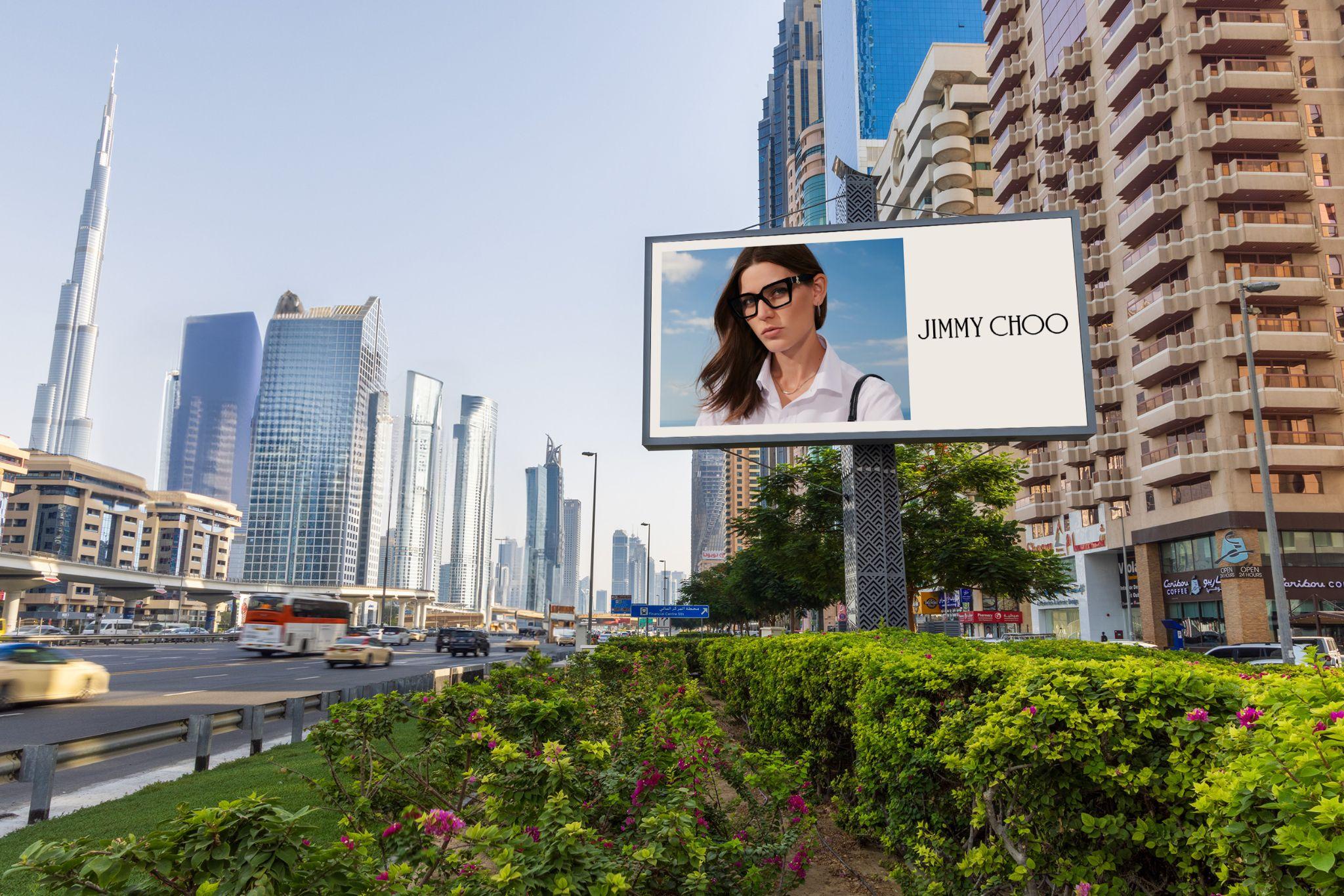 Roadside billboard on Sheikh Zayed Road with the Burj Khalifa and the Downtown Dubai skyline behind